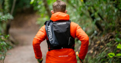 Corredor utilizando mochila de hidratação durante treino em trilha